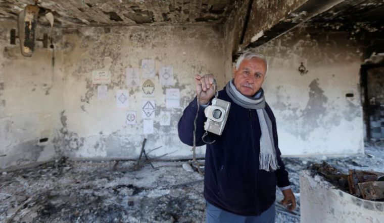 An Iraqi Christian man stands in his burned-out home in Qaraqosh in February 2017.