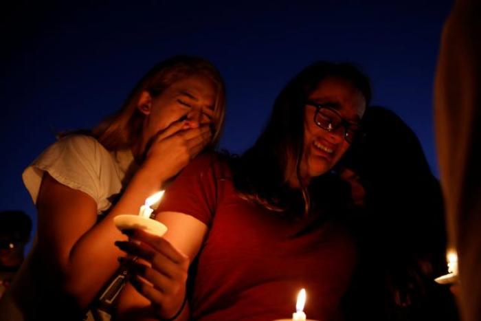 Students mourn during a candlelight vigil for school shooting victims in Parkland, Florida, on February 15, 2018.