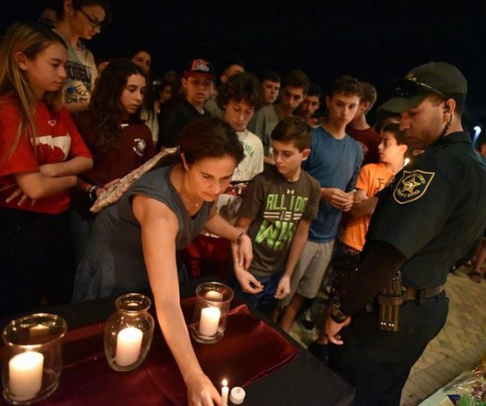 Community members mourn during a candlelight vigil for school shooting victims in Parkland, Florida, on February 15, 2018.