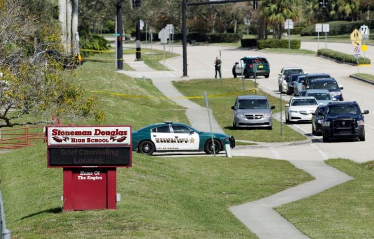 A message about grief counseling appears on an electronic signboard at Marjory Stoneman Douglas High School one day after a shooting at the school left 17 dead, in Parkland, Florida, U.S., February 15, 2018.
