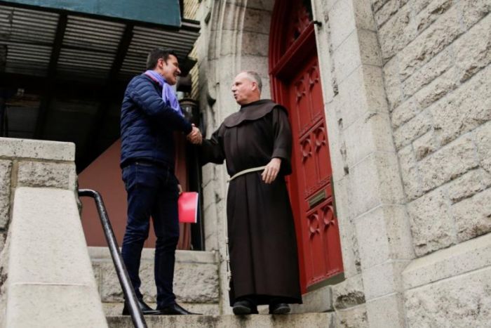 Chilean victim of clerical sexual abuse Juan Cruz shakes hands with a church member as he exits a meeting with investigator, Archbishop Charles Scicluna of Malta in New York City, New York, U.S., February 17, 2018.