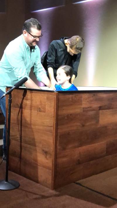 A frail looking Shane Hall (R), the late pastor of First Southern Baptist Church in Oklahoma City, Oklahoma, baptizes his daughter Mallory on Sunday February 11, 2018, days before his death from stomach cancer on Friday February 16, 2018.