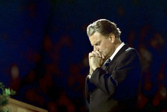 Billy Graham prays, 1968
