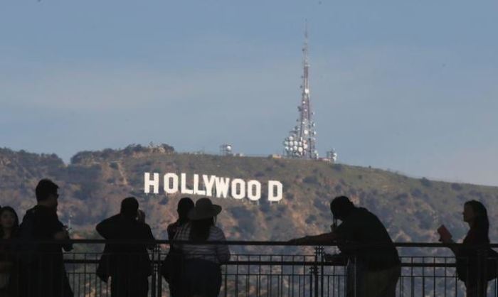 People looking and taking photos of the iconic Hollywood sign in California