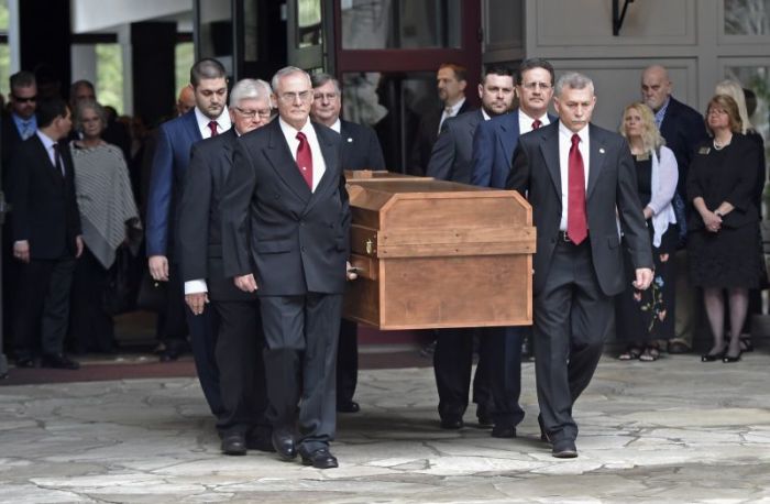 Pallbearers carry the body of Rev. Billy Graham before it leaves the Billy Graham Training Center at The Cove on Saturday, Feb. 24, 2018, in Asheville, N.C.