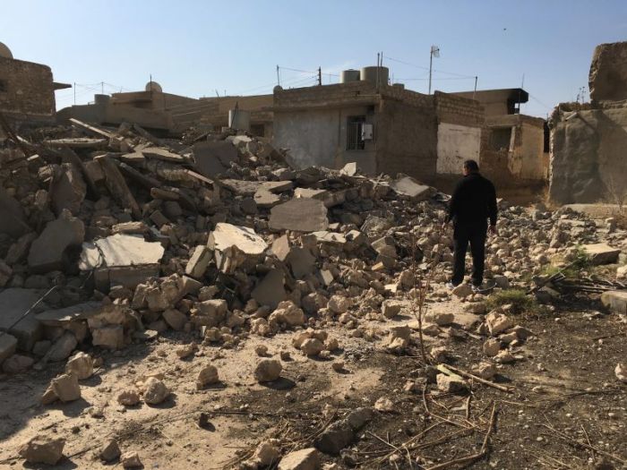 Father Thabet Habib inspects damage in the town of Karamles, Iraq right after the town was liberated from the Islamic State in October 2016.