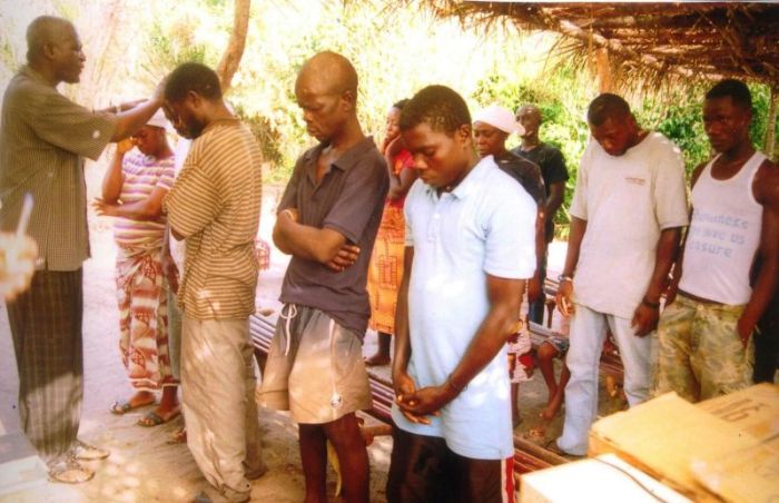 Pastor James Cuffee of Christ Evangelistic Fellowship Ministries in Liberia prays before baptizing new converts in this undated photo.