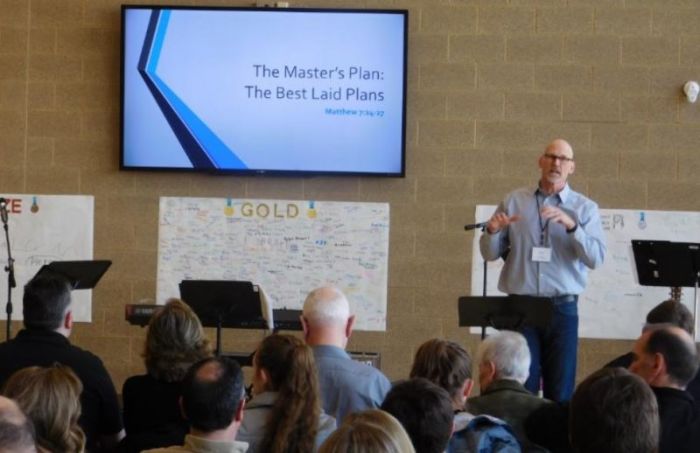 Former NFL player and NorthLight Community Church Pastor Kurt Ploeger preaches at the first public worship service for NorthLight, held at a primary school on Sunday, March 19, 2018.