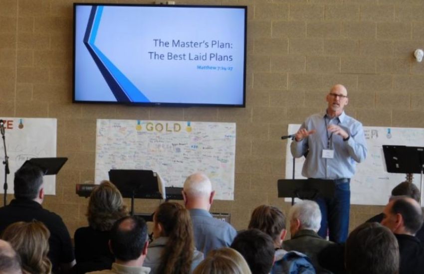 Former NFL player and NorthLight Community Church Pastor Kurt Ploeger preaches at the first public worship service for NorthLight, held at a primary school on Sunday, March 19, 2018.