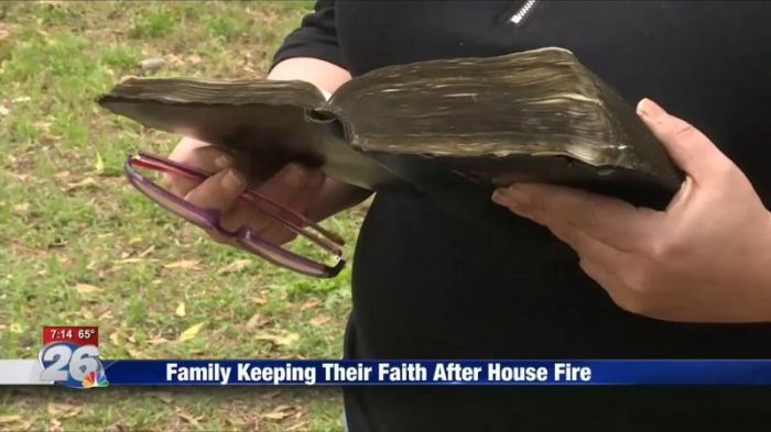 Wendy Crawley holding the undamaged family Bible that survived the fire that destroyed their home in North Augusta, South Carolina, in March 2018.
