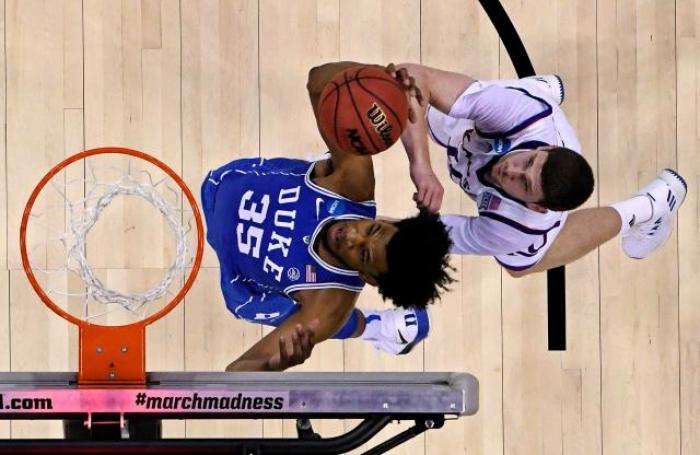 Duke Blue Devils forward Marvin Bagley III grabs a rebound against Kansas Jayhawks guard Sviatoslav Mykhailiuk during the first half in the championship game of the Midwest regional of the 2018 NCAA Tournament at CenturyLink Center.