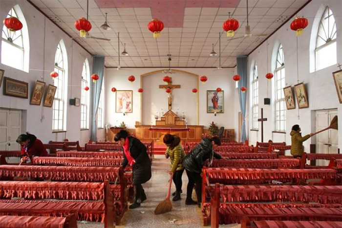 Members of the congregation clean the unofficial catholic church after Sunday service in Majhuang village, Hebei Province, China.