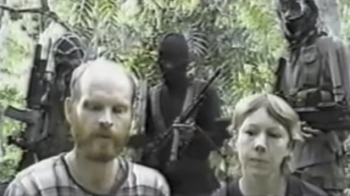 Martin (L) and Gracia (R) Burnham record a video while being held hostage by Abu Sayyaf terrorists in the Philippines between May 27, 2001 and June 7, 2002.