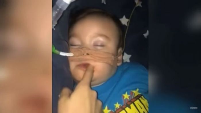 UK baby Alfie Evans in an undated video with his parents coating his lips with chocolate.