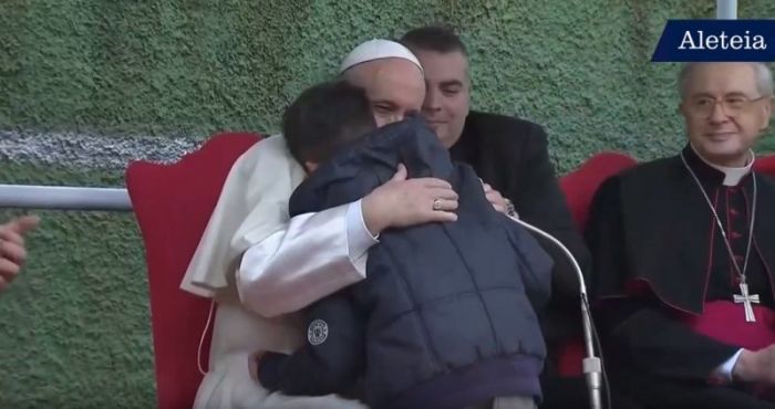 The Vatican's Pope Francis embracing a boy who asked him a question about Heaven on April 15, 2018.