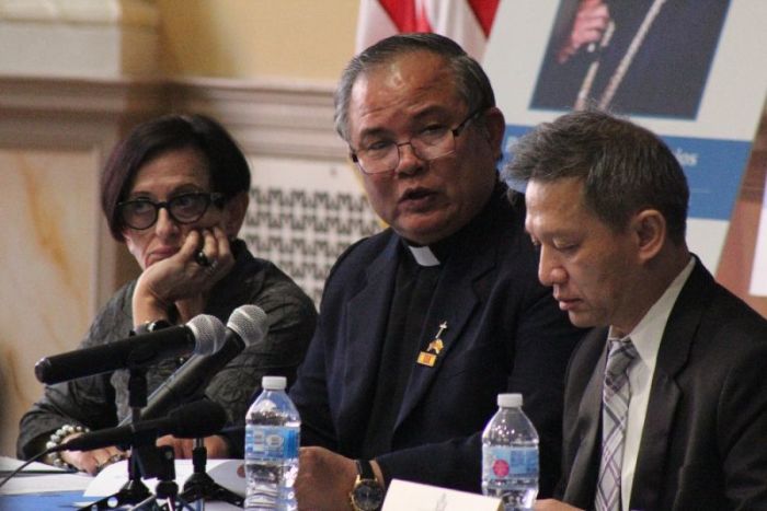 Pastor Nguyen Cong Chinh (M) speaks during a United States Commission on International Religious Freedom summit in Washington, D.C. on April 18, 2018. He is flanked by Thang Dinh Nuguyen (R) and USCIRF's Judy Golub (L).