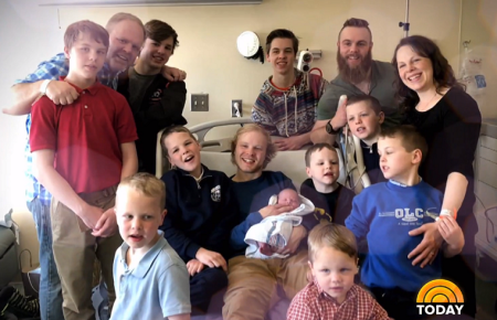 Jay and Kateri Schwandt pose with the newest addition to their 14-member brood of sons - Finley Sheboygan Schwandt.