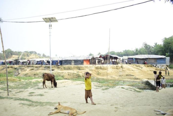 A Rohingya boy walks around a refugee camp in Cox's Bazar, Bangladesh in March 2018.