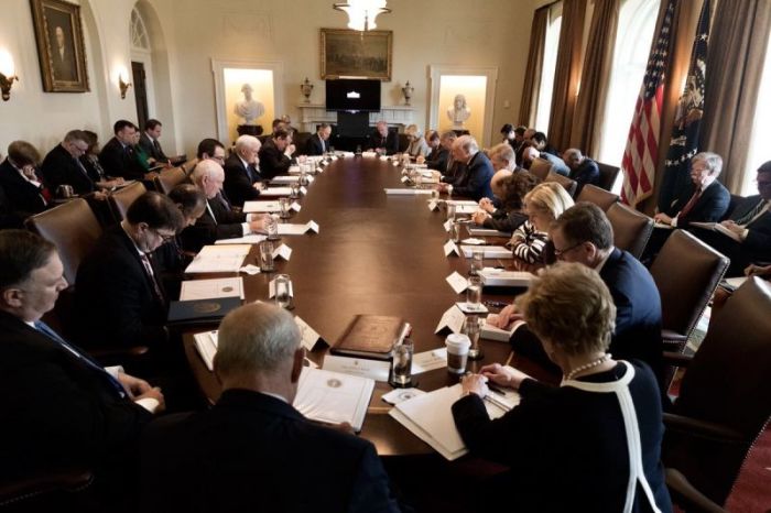 President Donald Trump prays with members of his cabinet at the White House on April 9, 2018.