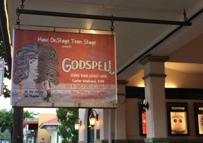 A sign advertising a production of the 1970s musical 'Godspell.'