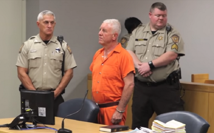 Christian businessman Roger Self, 62 (in orange jumpsuit), appears in court in North Carolina on Monday May 21, 2018. He has been charged with the murders of his daughter Katelyn Self, 26, and daughter-in-law, Amanda Self.