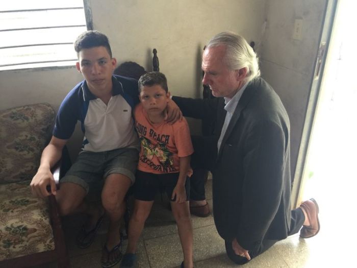 Pastor Bill Devlin of Infinity Bible Church comforting children who lost their parents on May 23, 2018, in Cuba.