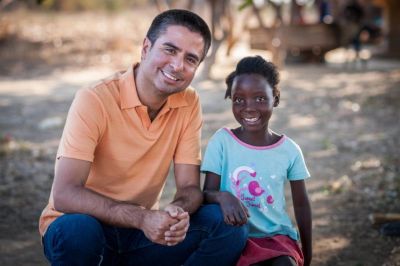 Edgar Sandoval poses with an 8-year-old girl named Faith in Kapululwe, Zambia. Faith is Sandoval's World Vision sponsored child.