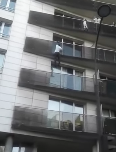Mamoudou Gassama climbs up to save a child dangling four stories high.