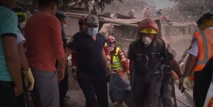 Rescue workers providing aid following the eruption of the Fuego volcano in Guatemala on June 3, 2018.