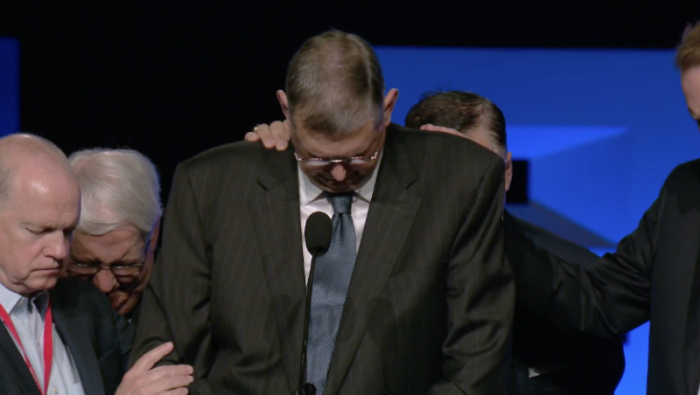 Southern Baptists pray for Jeffrey Bingham, interim president at Southwestern Baptist Theological Seminary, during their annual meeting in Dallas, Texas, June 13, 2018.