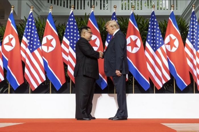 U.S. President Donald Trump (R) and North Korean leader Kim Jong Un (L) on June 12, 2018, shake hands during their widely anticipated summit in Singapore.