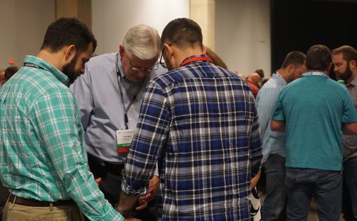Messengers pray together at the Southern Baptist Convention's Annual Meeting at the Kay Bailey Hutchison Convention Center in Dallas, Texas, on June 13, 2018.
