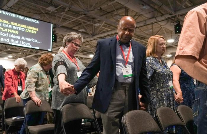 Ray Brantley, a messenger from Texas, front, prays for unity June 12, during the first session of the two-day Southern Baptist Convention's annual meeting at the Kay Bailey Hutchison Convention Center in Dallas, Texas, on June 12, 2018.