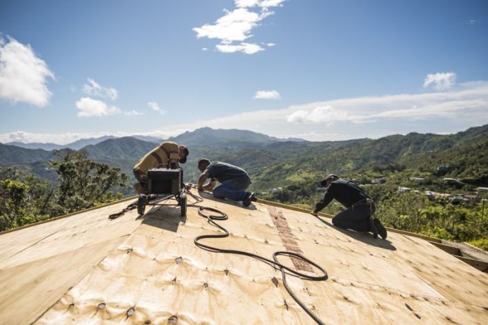 Locally hired workers repair the roof of Iglesia Cristiana Carismática Monte De Sión in Adjuntas, Puerto Rico, one of more than 55 churches Samaritan's Purse plans to repair on the island.