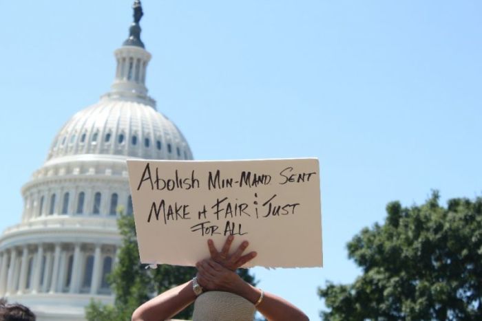 A demonstrator holds up a sign during a rally held outside of the United States Capitol Building in Washington, D.C., to call for criminal justice reform and the passage of the FIRST STEP Act on July 10, 2018.