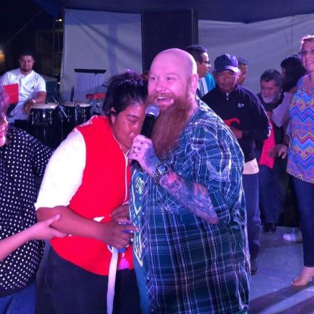 Healing evangelist Todd Bentley embraces a woman at a revival service.