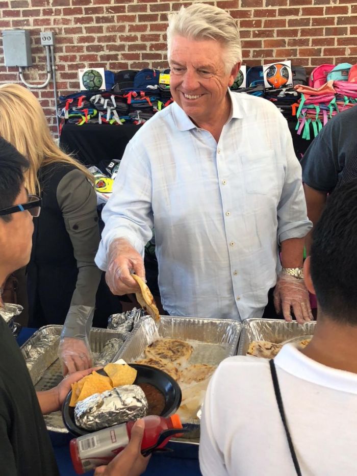 Jack Graham, pastor of Prestonwood Baptist Church in in Plano, Texas, serves lunch to immigrant children at the Youth for Tomorrow residential campus in Bristow, Virginia on July 13, 2018.