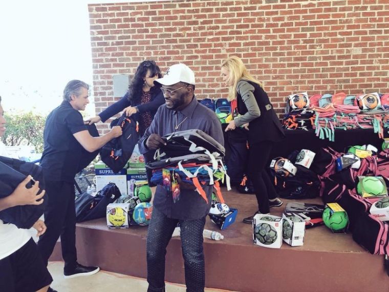 Harry Jackson, pastor of Hope Christian Church in Beltsville, Maryland, hands out backpacks to immigrant children at the Youth for Tomorrow residential campus in Bristow, Virginia on July 13, 2018.