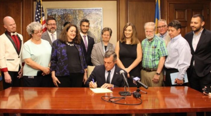 Delaware Governor John Carney signs a bill banning gay conversion therapy for minors on Monday, July 23, 2018.