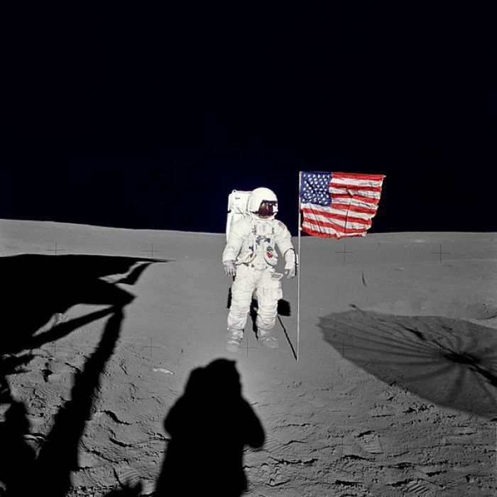 Astronaut Edgar Mitchell poses for a picture along with the U.S. flag while standing on the moon's surface