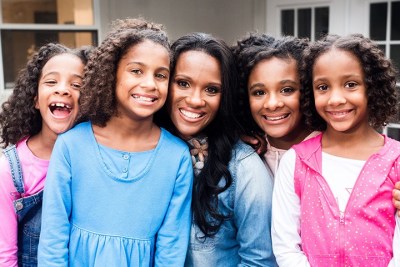 Wynter Pitts (center), founder of For Girls Like You magazine, seen posing with her four daughters.