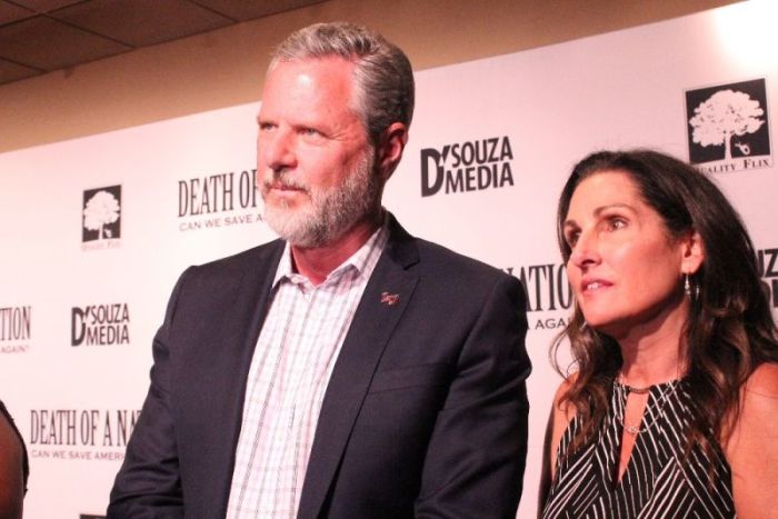 Jerry Falwell Jr. speaks to reporters at the advanced screening of Dinesh D'Souza's documentary 'Death of a Nation' at the E Street Cinema in Washington, D.C. on Aug. 1, 2018. He is flanked by his wife, Becki.