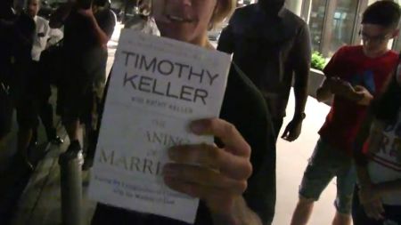 Justin Bieber holding up Tim Keller's 