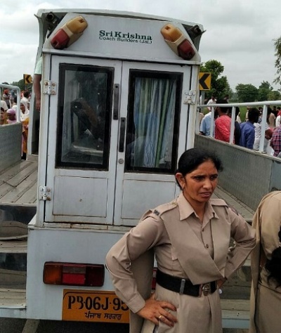 The girl's body is taken away, with crowds gathering around.