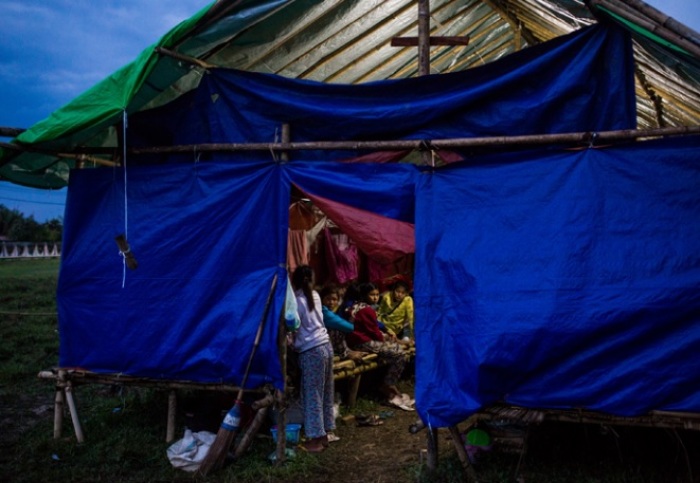 Displaced Kachin rest in a temporary shelter at a Catholic Church in Kinsayar Ward of Tanai Township, Kachin State of Myanmar. Fighting between the Myanmar military and the Kachin Independence Army in April 2018 trapped thousands of Kachin civilians in nearby forests for several weeks without humanitarian aid. The Myanmar military repeatedly denied aid groups access to those trapped and refused to evacuate them.