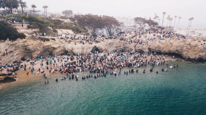 Hundreds gather to be baptized at Pirates Cove Beach in Newport Beach, California on Sept. 8, 2018. The mass baptism was organized by Greg Laurie's Harvest Christian Fellowship.