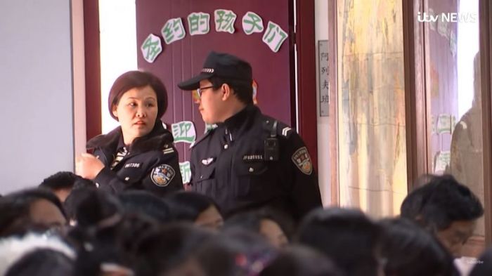 Police officers monitor a church service in China in this footage posted on March 22, 2018.