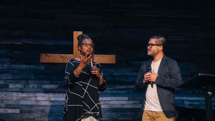 Pastor Brenda Salter McNeil (L) is blessed as the new transitional pastor at Quest Church in Seattle, Washington on Sunday September 23, 2018. Founding Pastor Eugene Cho (R) will spend his final day at the church on Sunday September 30, 2018.