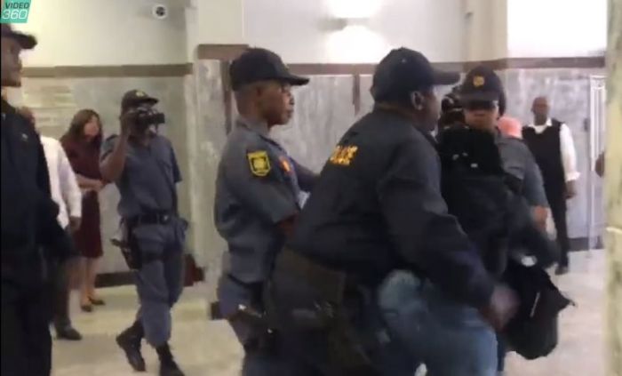 A video has been released of a woman shouting, kicking, and being dragged out from Port Elizabeth High Court in South Africa on October 9, 2018.