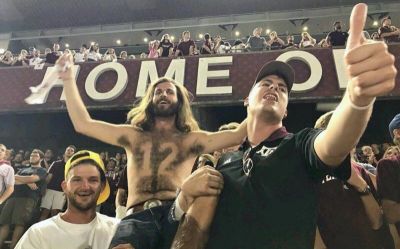 12th Man Jesus hoisted on shoulders of his friends, James and John